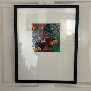 Stained glass picture of wine, cheese and grapes.